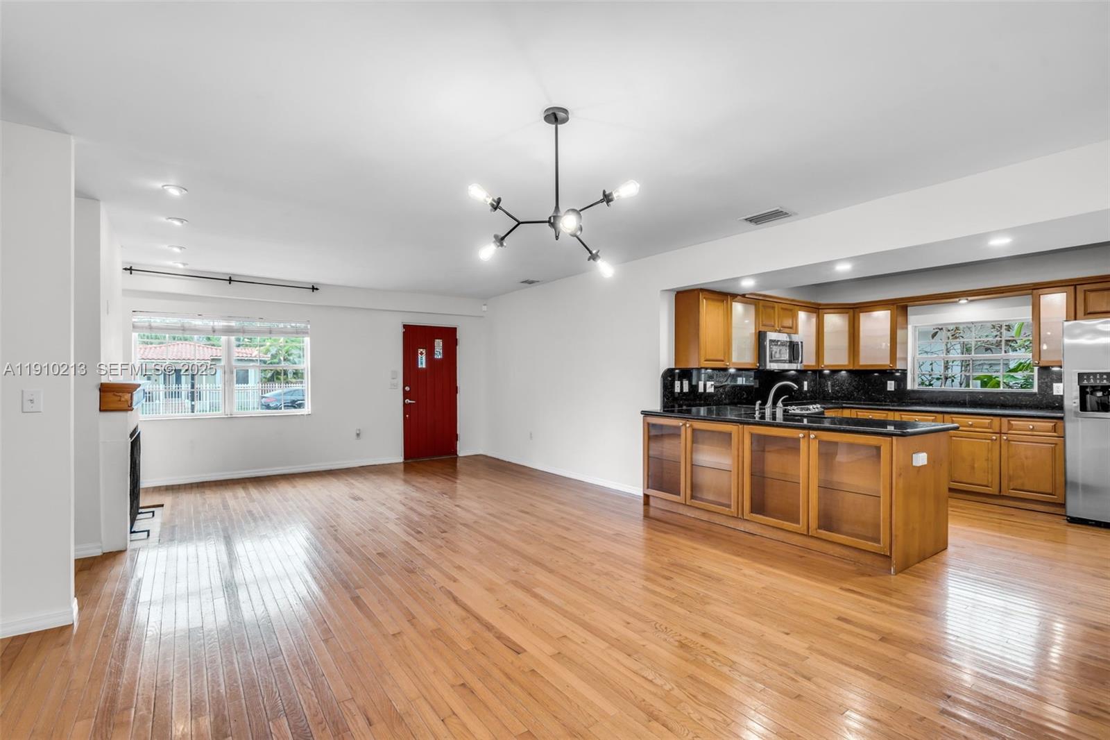 4416 Southwest 14th Street Miami, FL 33134 - Photo 8 of 33 a view of a kitchen with kitchen island wooden floor and stainless steel appliances