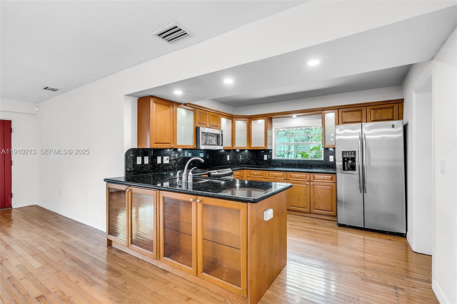 4416 Southwest 14th Street Miami, FL 33134 - Photo 10 of 33 a kitchen with stainless steel appliances granite countertop a stove a sink and a refrigerator