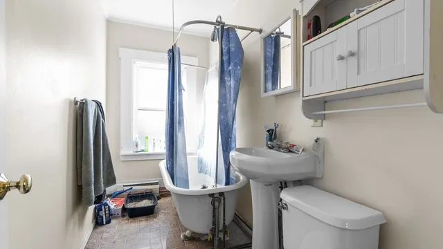 a bed sitting in a bedroom next to a window