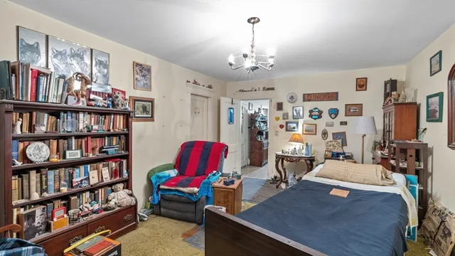 a bedroom with two beds and a bed