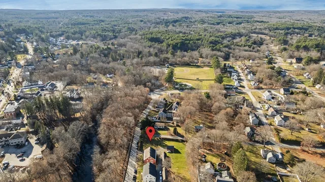 an aerial view of a houses with a yard