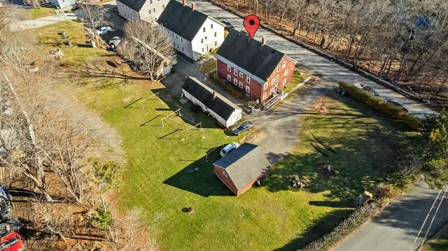an aerial view of a houses with a yard
