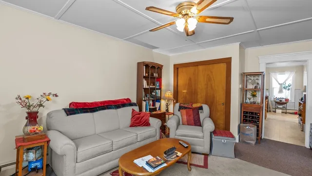 a living room with furniture workspace and a flat screen tv