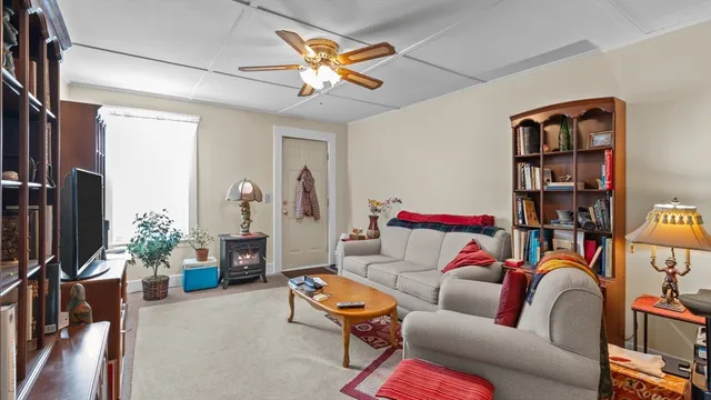 a dining room with stainless steel appliances kitchen island granite countertop a table and chairs