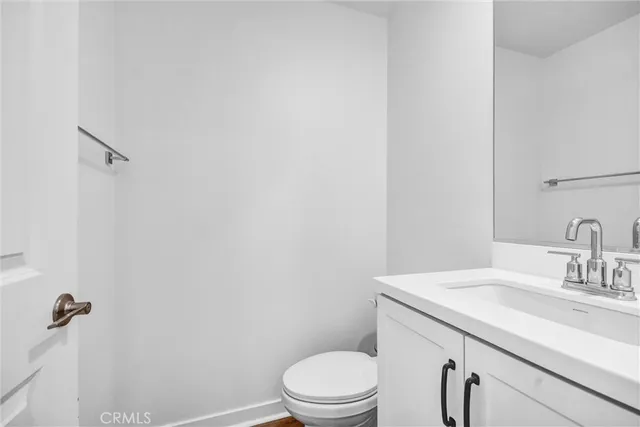 a bathroom with a sink a toilet and vanity