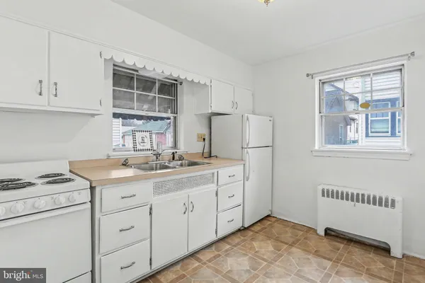a kitchen with cabinets appliances and a window