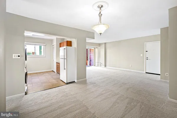 a view of a livingroom with wooden floor and a ceiling fan
