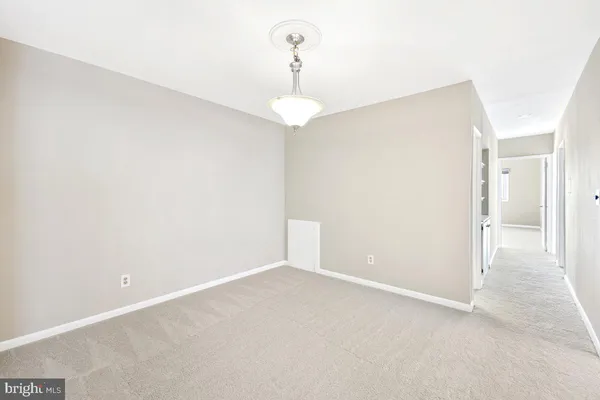 a view of an empty room with a chandelier