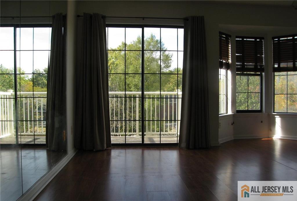 83 Crosspointe Drive, Unit 83 East Brunswick, NJ 08816 - Photo 11 of 11 a view of a large window with wooden floor