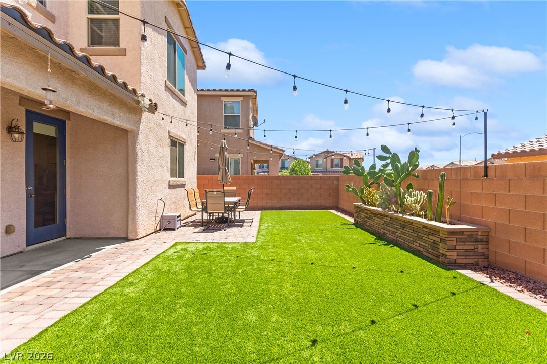 6435 Point Isabel Way Las Vegas, NV 89122 - Photo 45 of 57 A private, low-maintenance outdoor space featuring artificial turf and a charming patio for relaxed enjoyment.