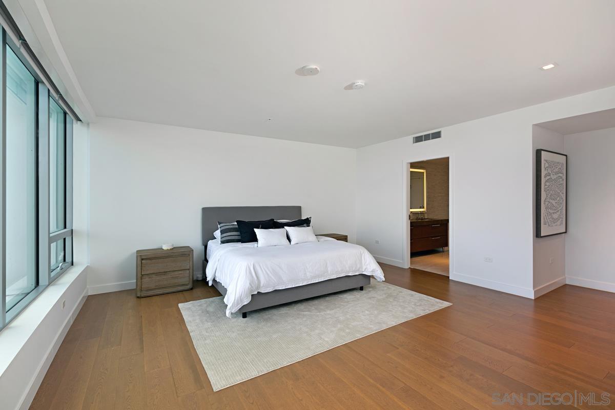 888 E Street, Unit 3501 San Diego, CA 92101 - Photo 17 of 46 a bedroom with a bed and wooden floor