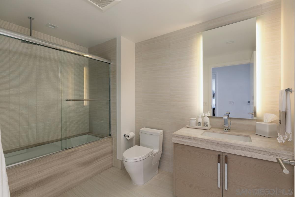 888 E Street, Unit 3501 San Diego, CA 92101 - Photo 24 of 46 a bathroom with a granite countertop sink toilet and shower