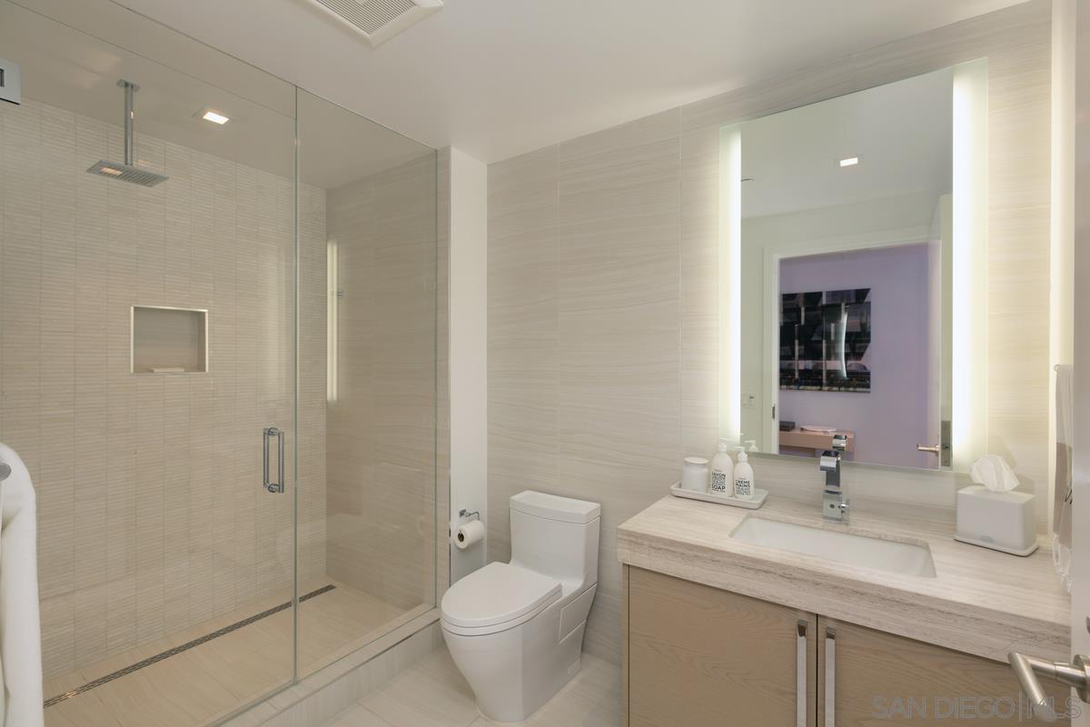 888 E Street, Unit 3501 San Diego, CA 92101 - Photo 28 of 46 a bathroom with a granite countertop sink toilet and shower