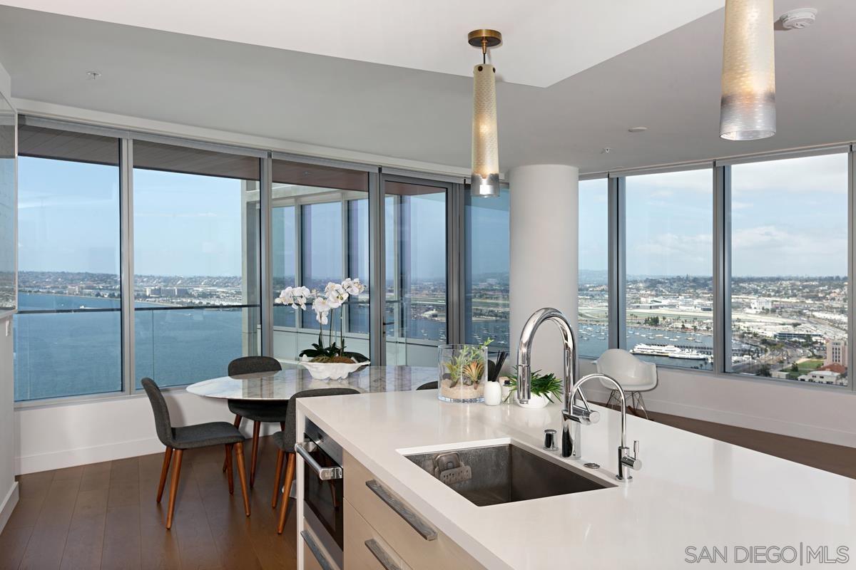 888 E Street, Unit 3501 San Diego, CA 92101 - Photo 8 of 46 a kitchen with a table chairs stove and sink