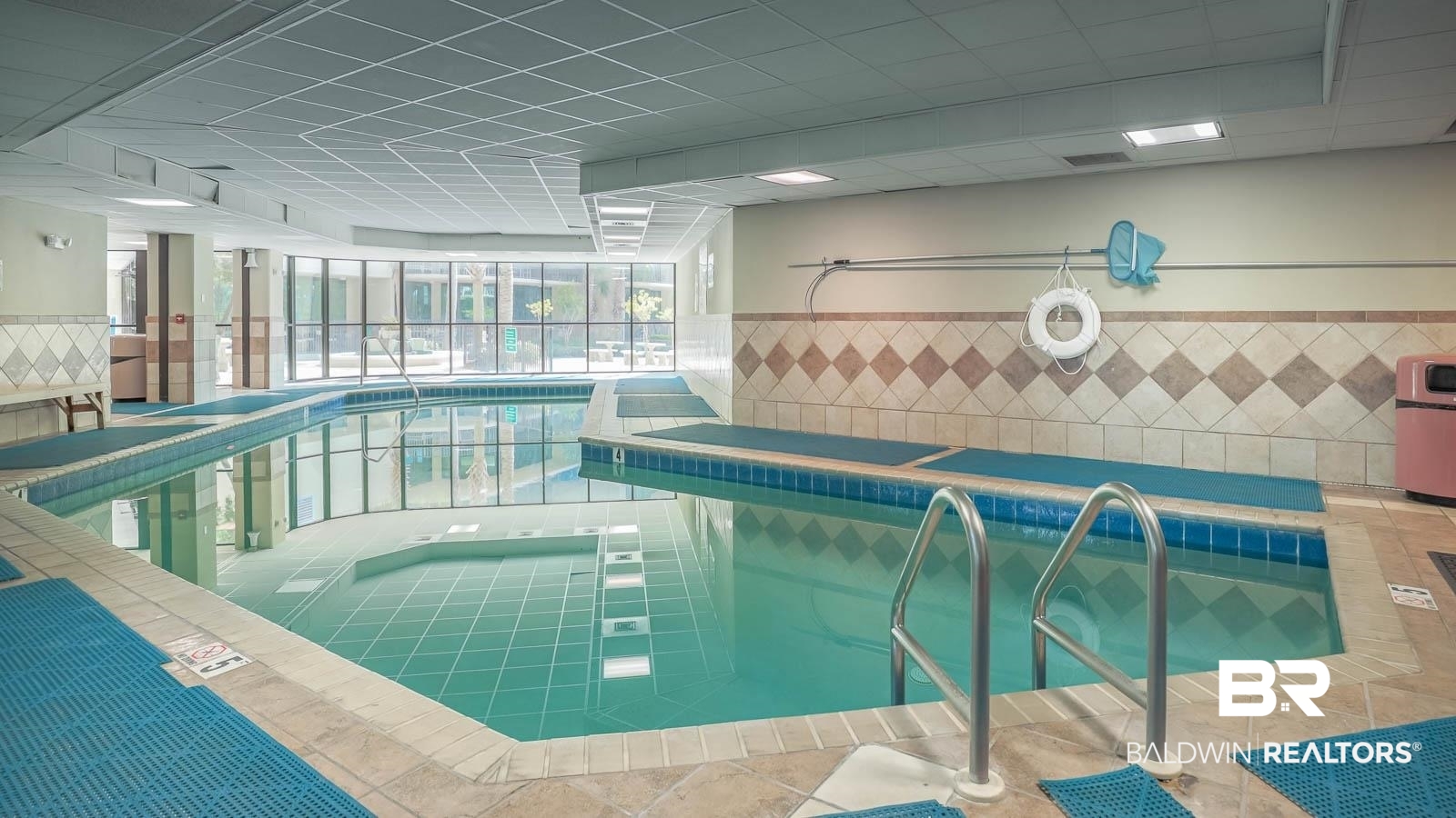 27580 Canal Road, Unit 1213 Orange Beach, AL 36561 - Photo 26 of 27 Indoor swimming pool with tile surround, integrated steps, and large windows