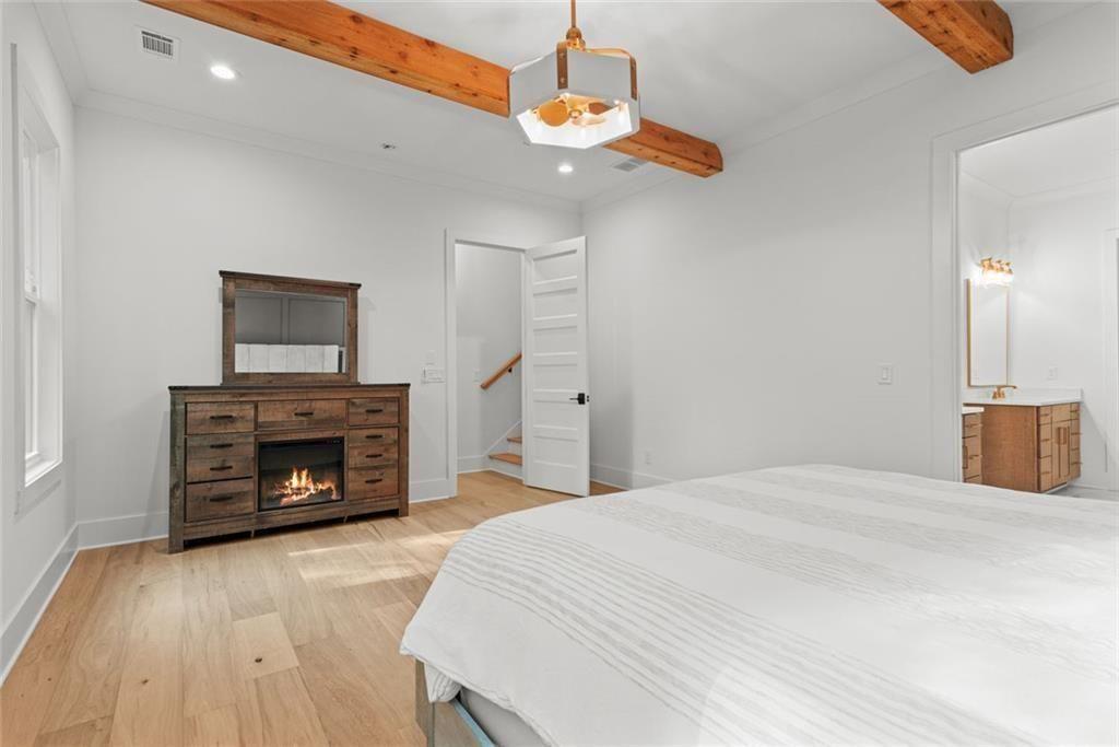 240 Highlands Ball Ground, GA 30107 - Photo 29 of 57 a bedroom with a bed and a fireplace