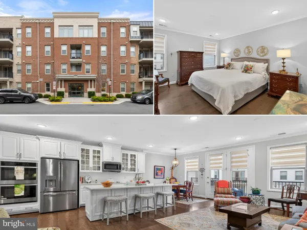 a living room with stainless steel appliances furniture and a kitchen view