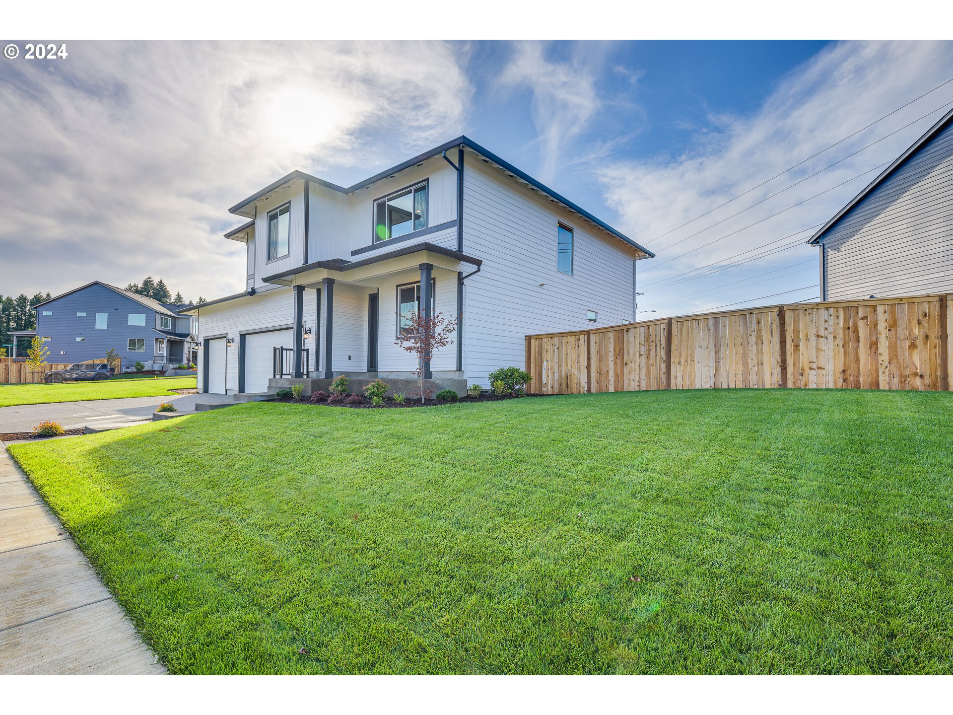 18660 Warm Springs Street, Unit 10 Sandy, OR 97055 - Photo 2 of 42 a view of a big house with a big yard potted plants and large tree