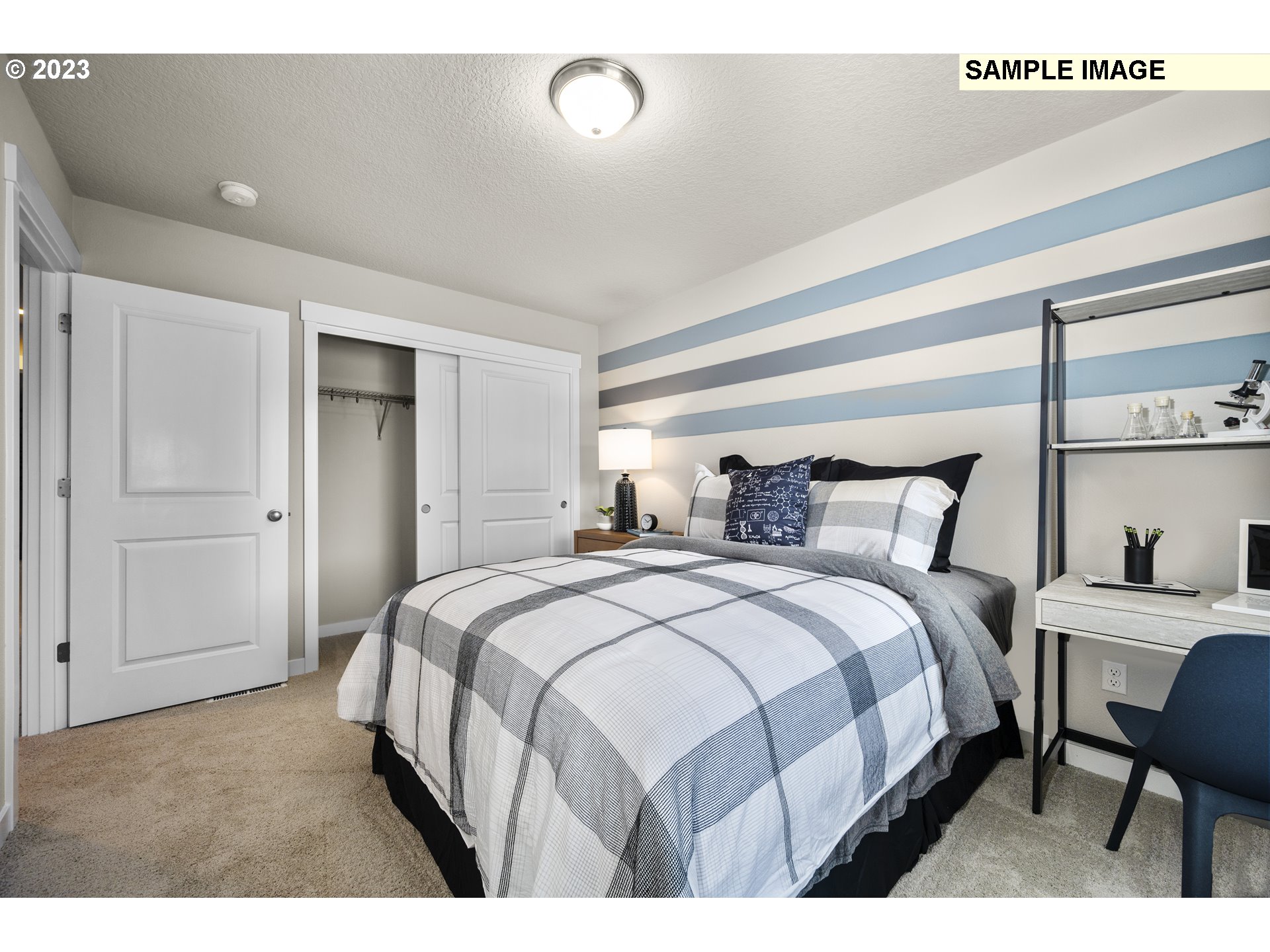 18660 Warm Springs Street, Unit 10 Sandy, OR 97055 - Photo 35 of 42 a bedroom with a bed a table and chair