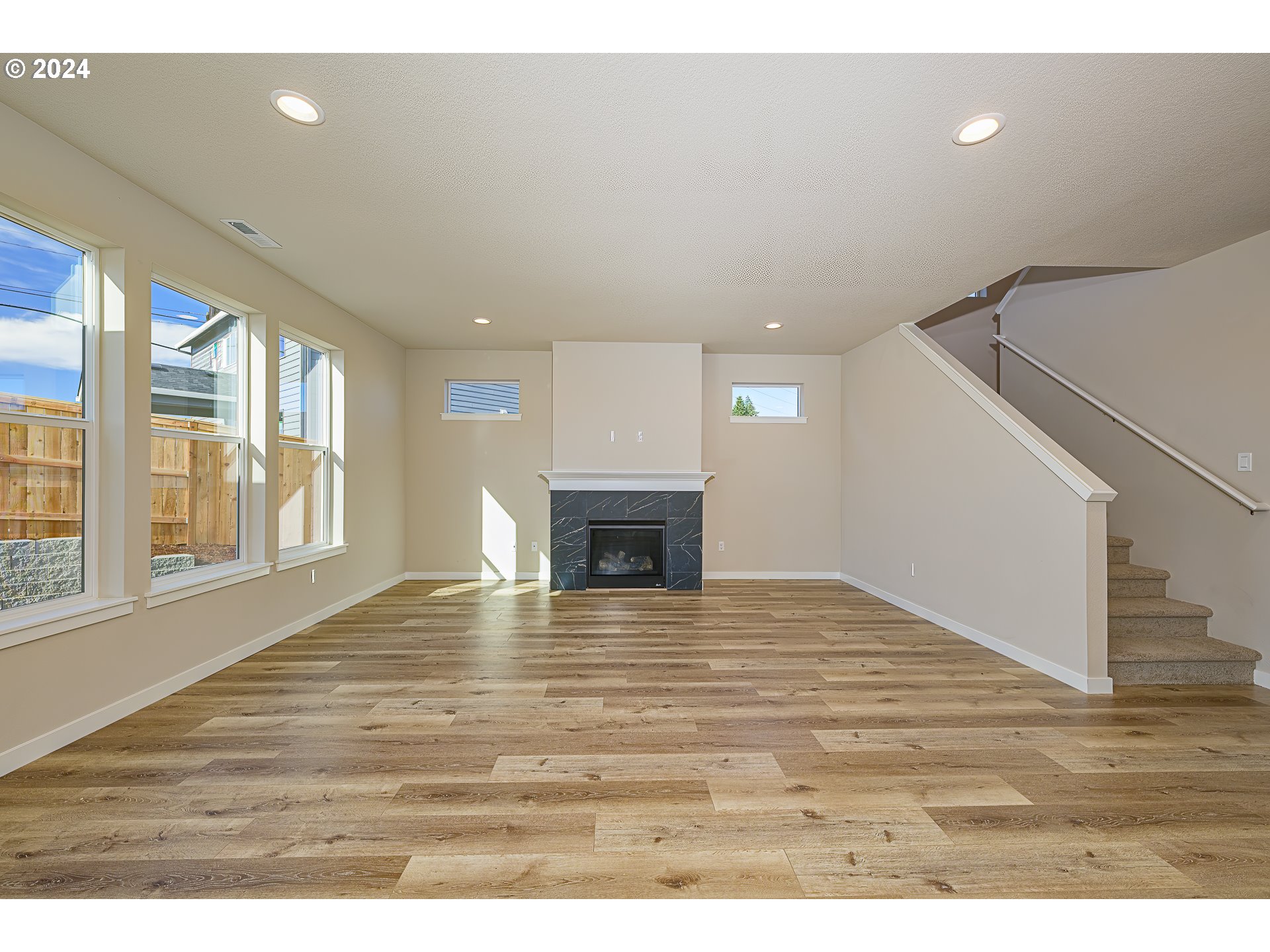 18660 Warm Springs Street, Unit 10 Sandy, OR 97055 - Photo 5 of 42 a view of an empty room with wooden floor and a window