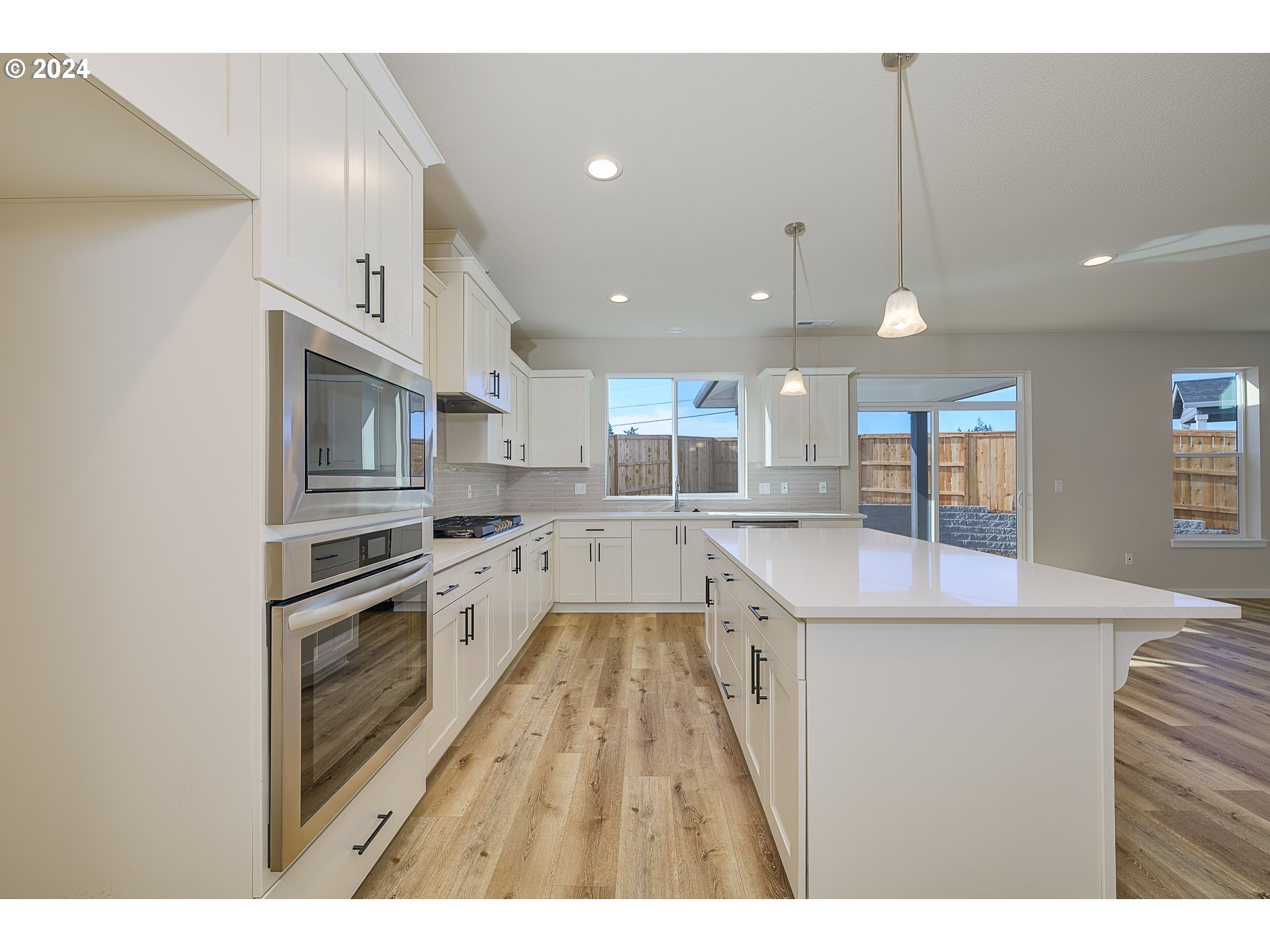 18660 Warm Springs Street, Unit 10 Sandy, OR 97055 - Photo 10 of 42 a kitchen with stainless steel appliances granite countertop a sink stove and refrigerator