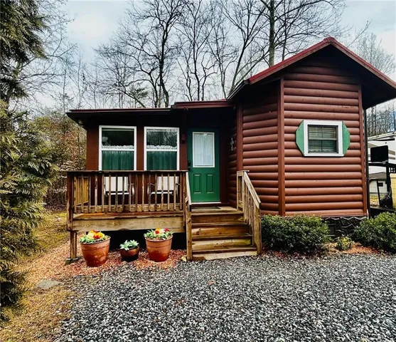 a view of a chair and table in the back yard of the house