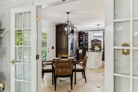 a view of a dining room with furniture and a chandelier