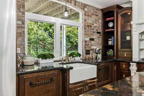 a kitchen with stainless steel appliances granite countertop a refrigerator and a stove top oven