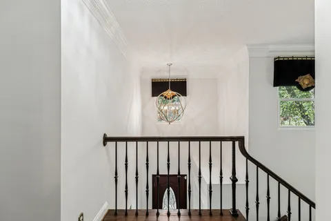 a bedroom with a bed and chandelier