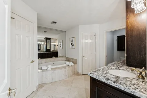 a balcony with wooden floor table and chairs