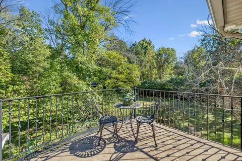 a bathroom with a granite countertop sink a mirror and a toilet