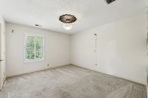 a view of a porch with furniture and floor to ceiling window