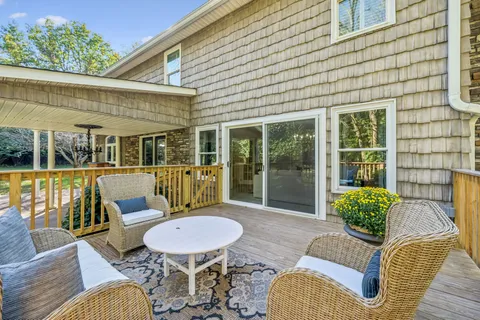 a view of a balcony with chair and potted plants