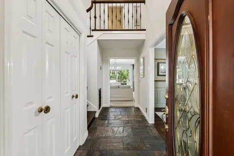 a dining room with furniture a chandelier and window