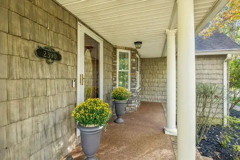 a view of a house with a yard and tree s