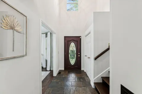 a view of a dining room with furniture and chandelier