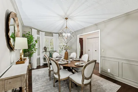 a living room with furniture a fireplace and a potted plant