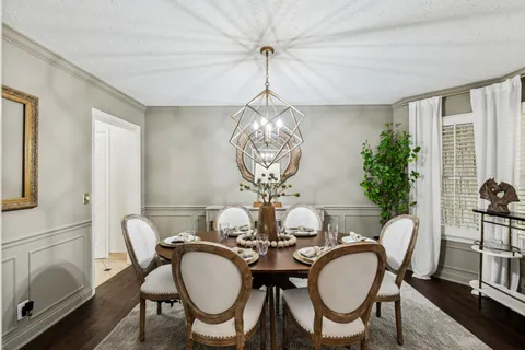 a living room with furniture a fireplace and a chandelier