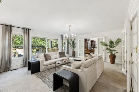 a kitchen with granite countertop a stove and a white refrigerator