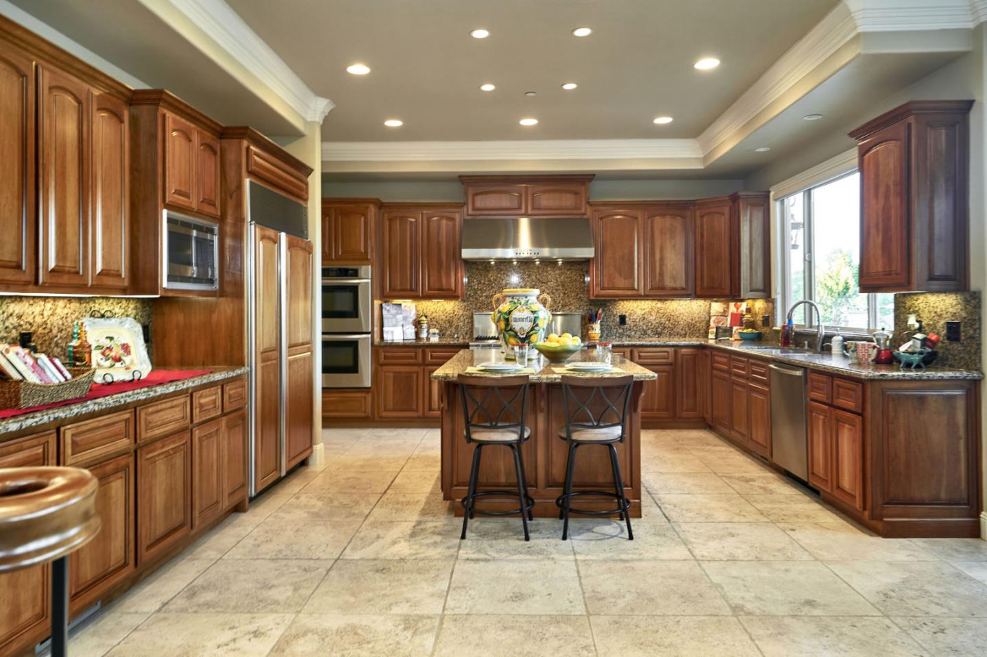 13800 Watsonville Road Morgan Hill, CA 95037 - Photo 14 of 74 a kitchen with stainless steel appliances kitchen island granite countertop a table and chairs