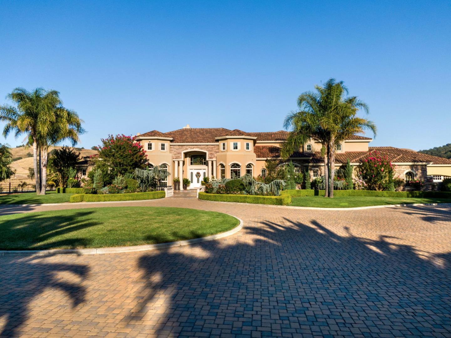 13800 Watsonville Road Morgan Hill, CA 95037 - Photo 6 of 74 a view of a white house with a big yard plants and palm trees