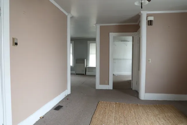 a view of a room with an empty space and wooden floor
