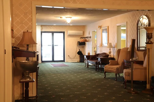 a living room with furniture and a floor to ceiling window
