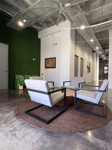a living room with patio furniture and a chandelier