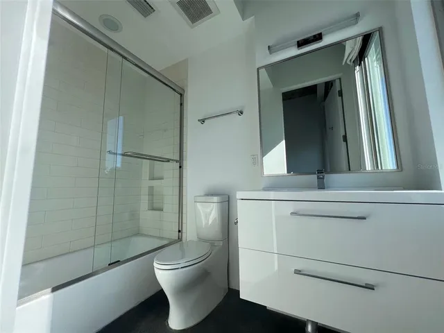 a bathroom with a toilet a sink and shower
