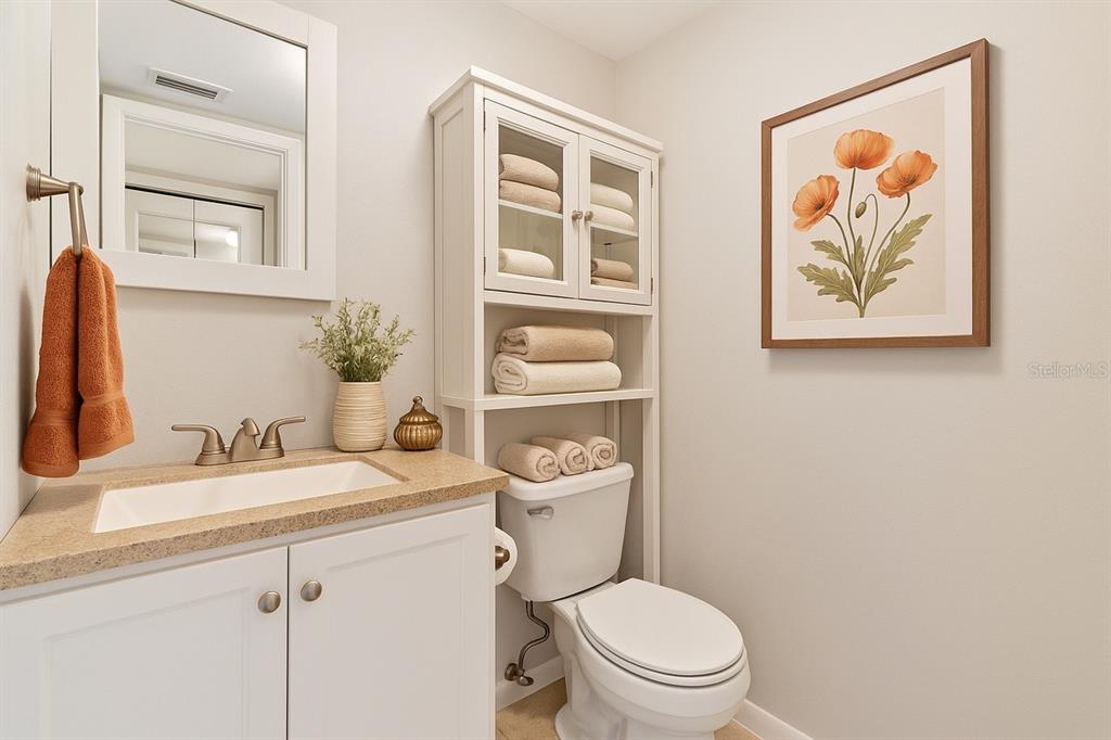 2025 Sylvester Road, Unit N312 Lakeland, FL 33803 - Photo 15 of 35 a bathroom with a toilet a sink and mirror