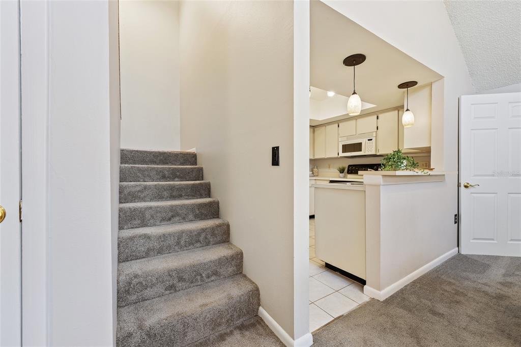 2025 Sylvester Road, Unit N312 Lakeland, FL 33803 - Photo 19 of 35 a view of a kitchen with white cabinets and white appliances