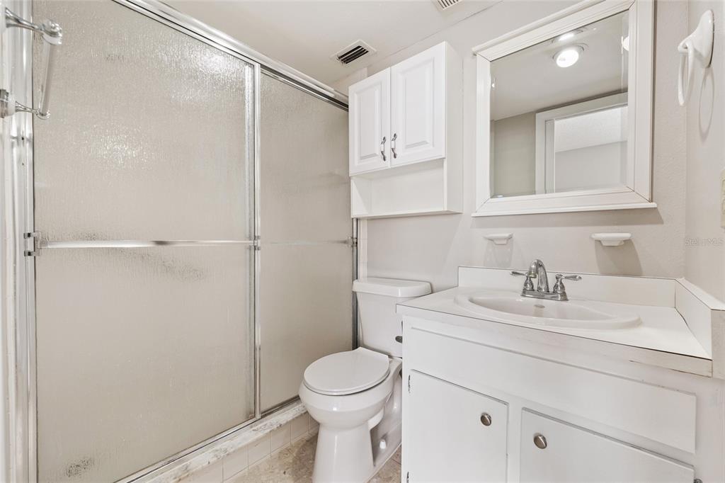 2025 Sylvester Road, Unit N312 Lakeland, FL 33803 - Photo 26 of 35 a bathroom with a sink a toilet and shower