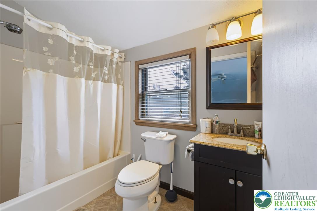 1605 Ridgeview Drive Lake Ariel, PA 18436 - Photo 24 of 40 Natural light brightens this full bathroom featuring stone countertops and vinyl flooring.
