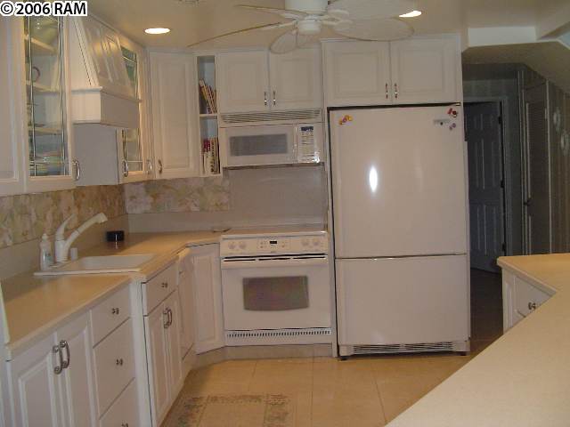 811 South Kihei Road, Unit 1F Kihei, HI 96753 - Photo 7 of 19 a white refrigerator freezer sitting inside of a kitchen